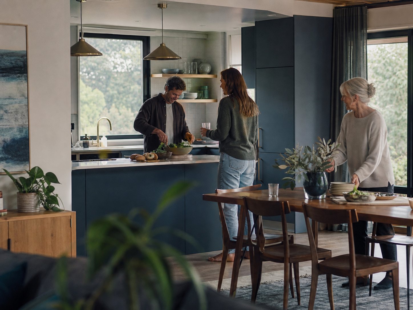 Illustrative scene of three people sharing an everyday moment at home.